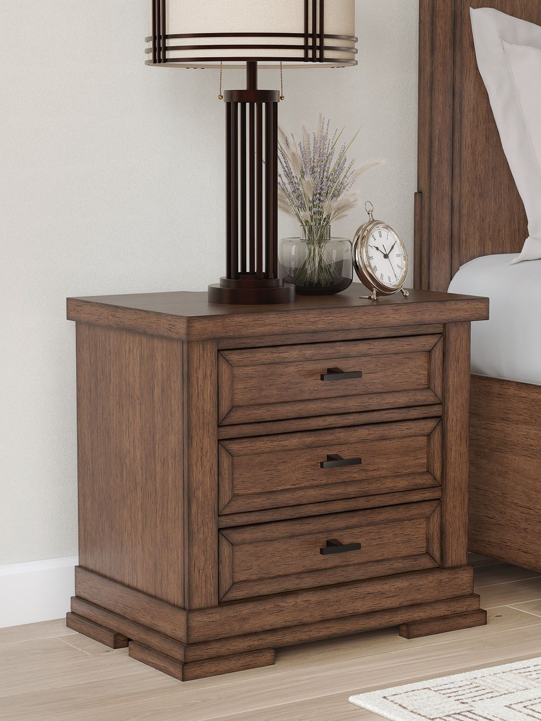 Medium brown three-drawer night stand with three bar-pull drawers