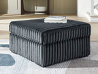 Oversized accent ottoman in blue-gray, ribbed texture, low block base