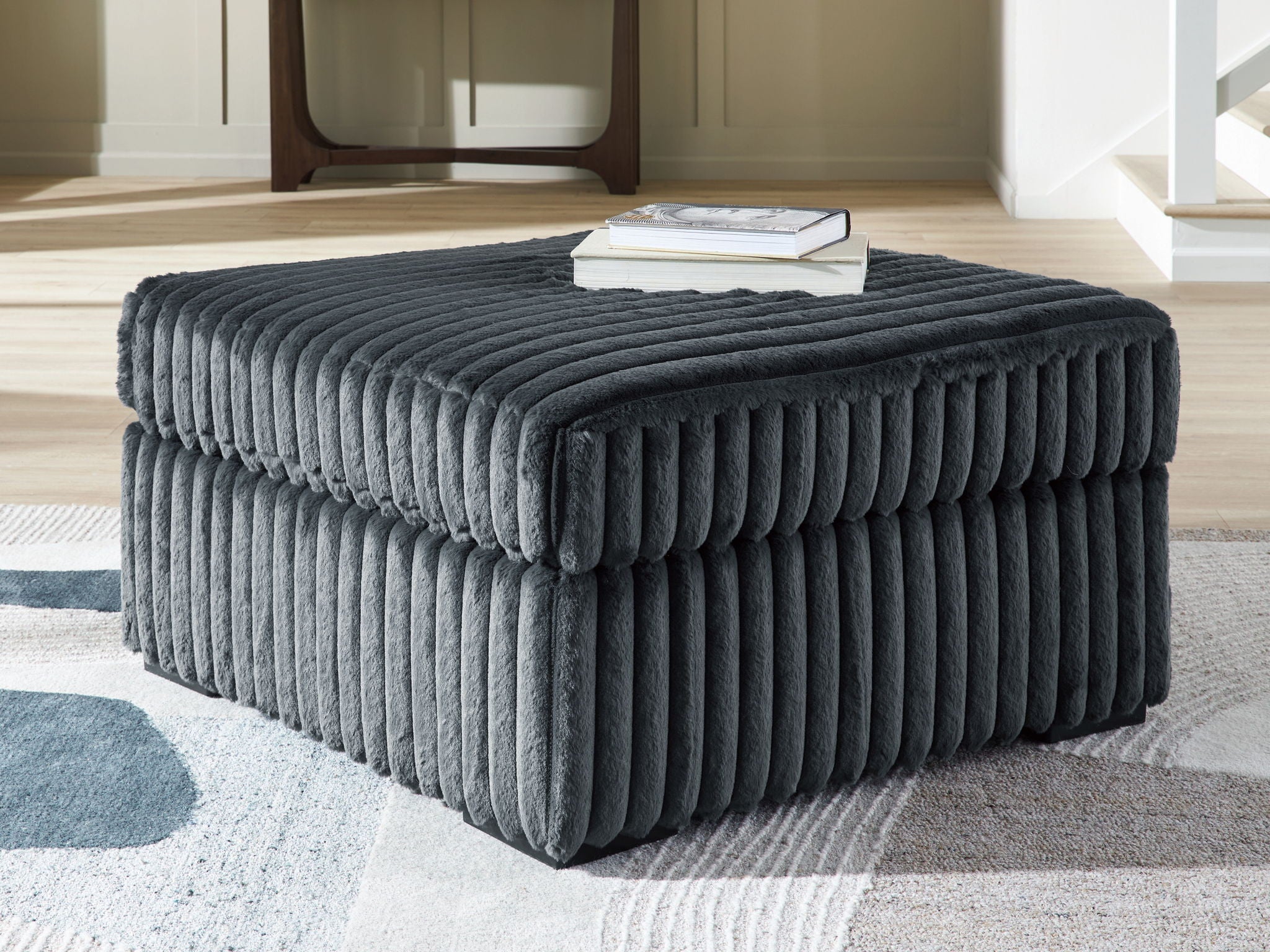 Oversized accent ottoman in blue-gray, ribbed texture, low block base