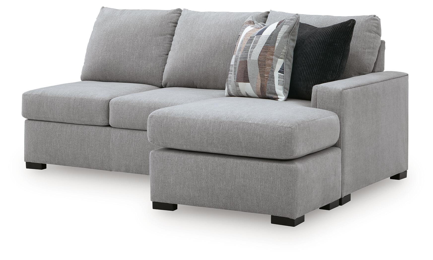 Light gray sofa chaise sectional with single chaise ottoman, curved arms, and patterned pillows