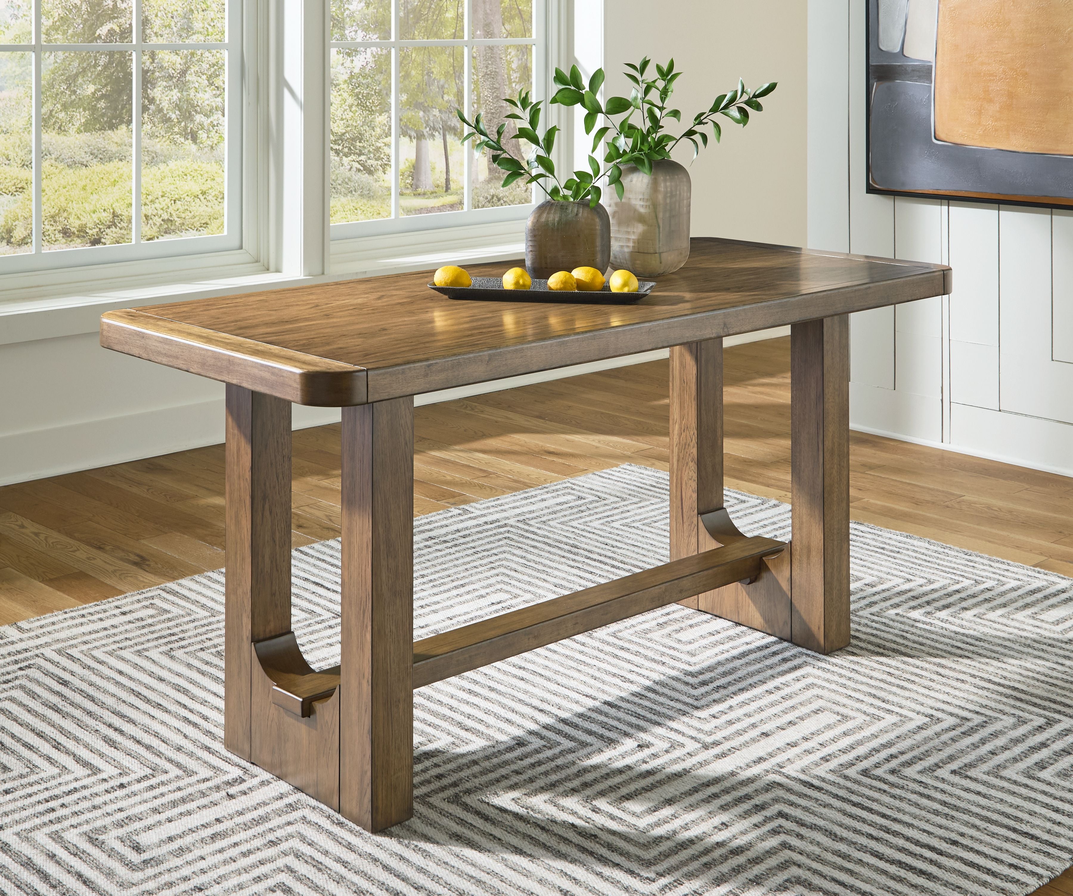 Rectangular dining table in light brown wood with lower shelf and sturdy corner supports