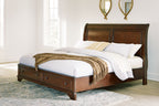 Brown king storage bed with paneled headboard and two foot drawers, shown with pillows