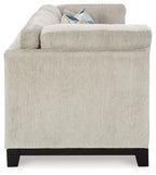 Stone fabric sofa with broad arms and dark wooden legs