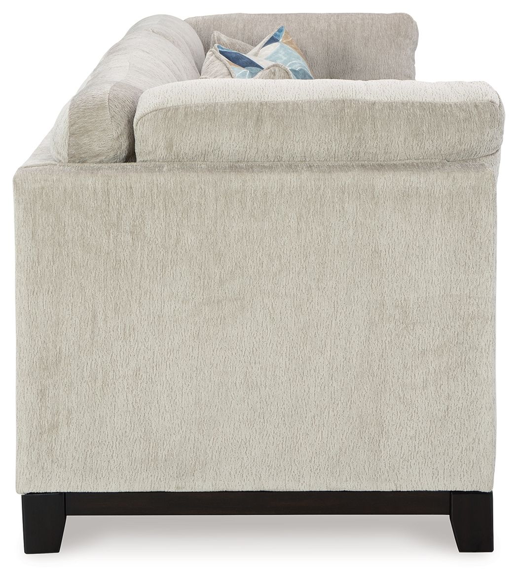 Stone fabric sofa with broad arms and dark wooden legs