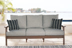 Grey upholstered sofa with two black-and-white patterned throw cushions