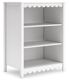 White platform bedroom bookcase with open shelves and scalloped trim