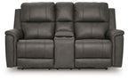 Power reclining loveseat with console, dark gray upholstery and padded armrests