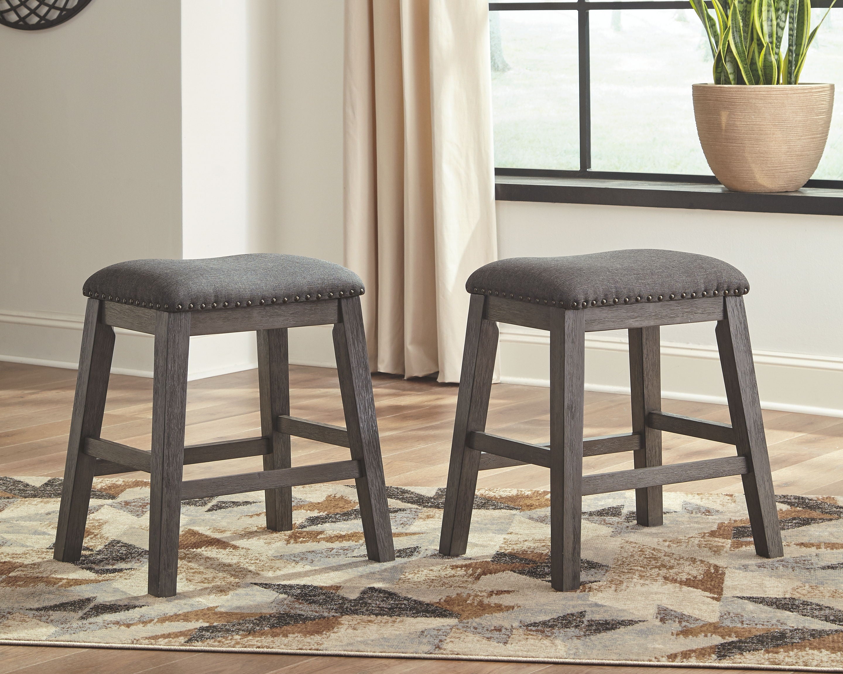 Pair of gray upholstered counter barstools with square legs