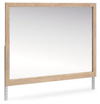 Tan wood bedroom mirror with rectangular frame and clear reflective glass