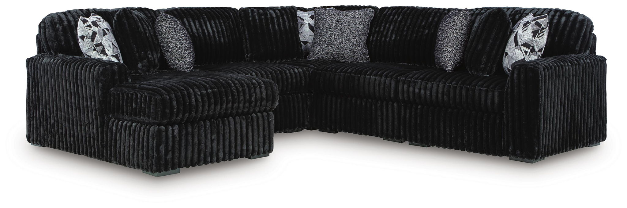 Black corduroy sectional sofa with corner chaise and patterned accent pillows