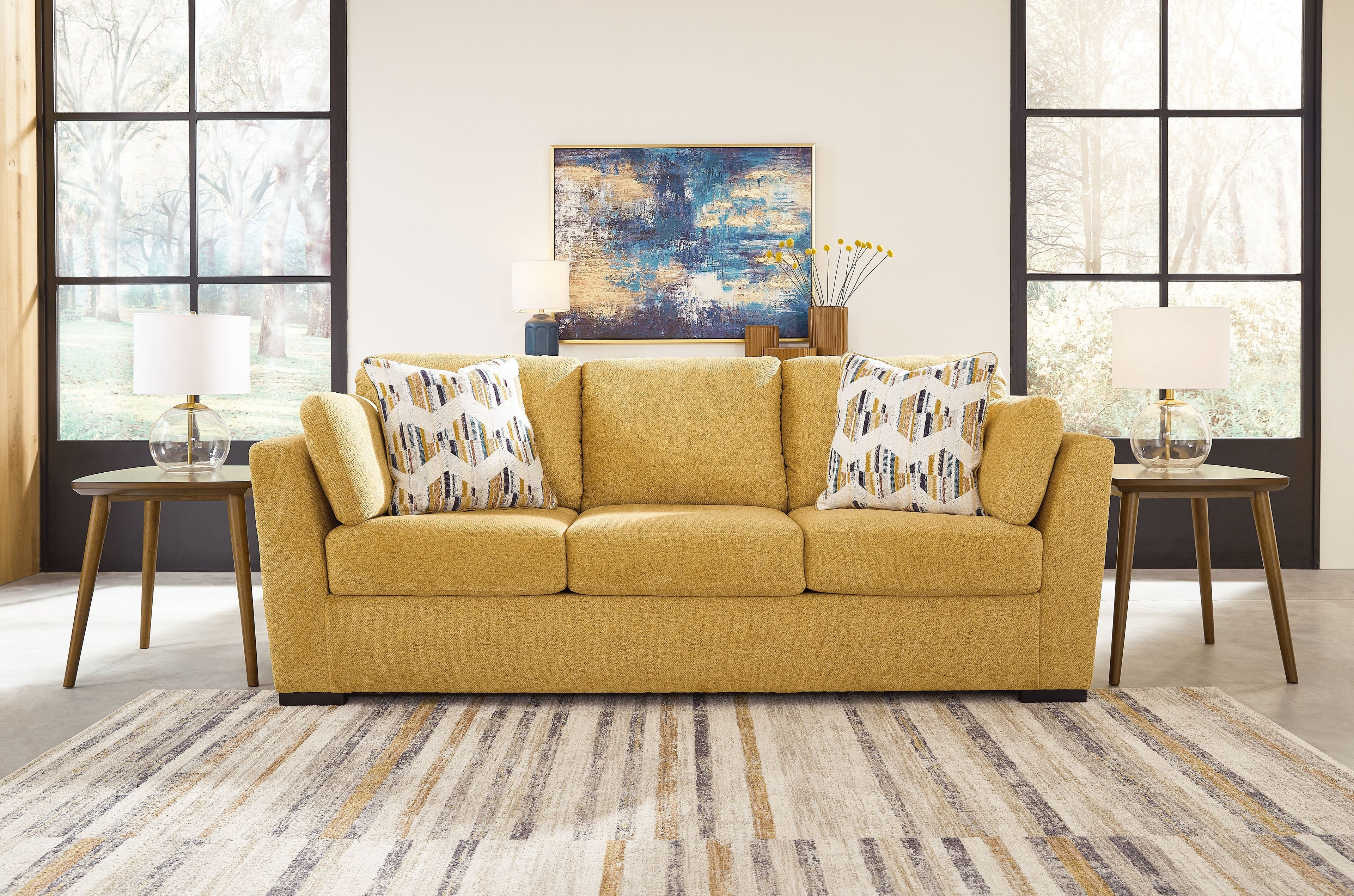 Keerwick sofa in sunflower yellow with patterned pillows, plush three-cushion seat