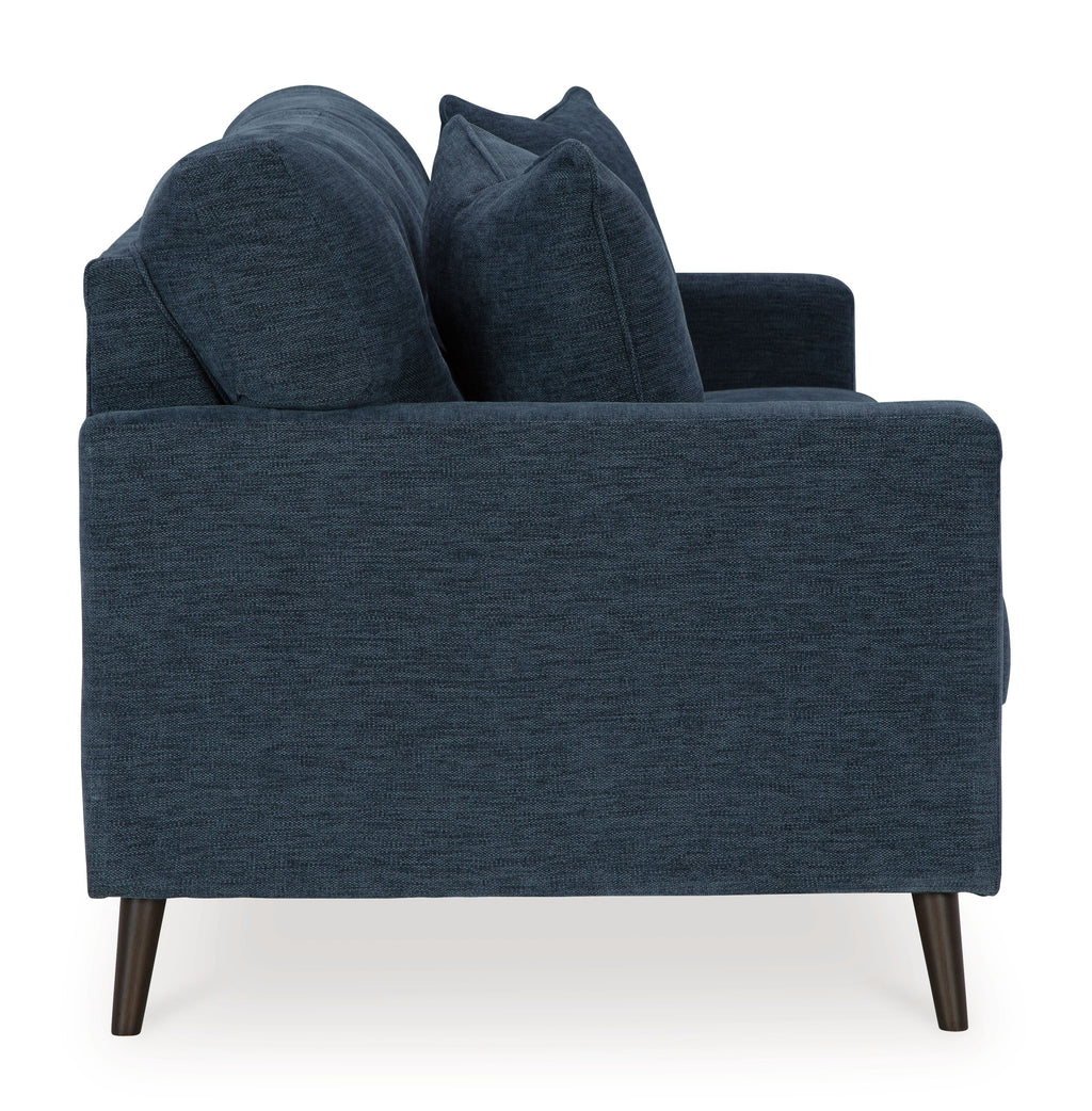 Navy blue sofa with three seat cushions and four back pillows