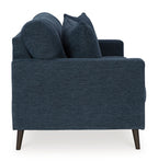 Navy blue sofa with three seat cushions and four back pillows