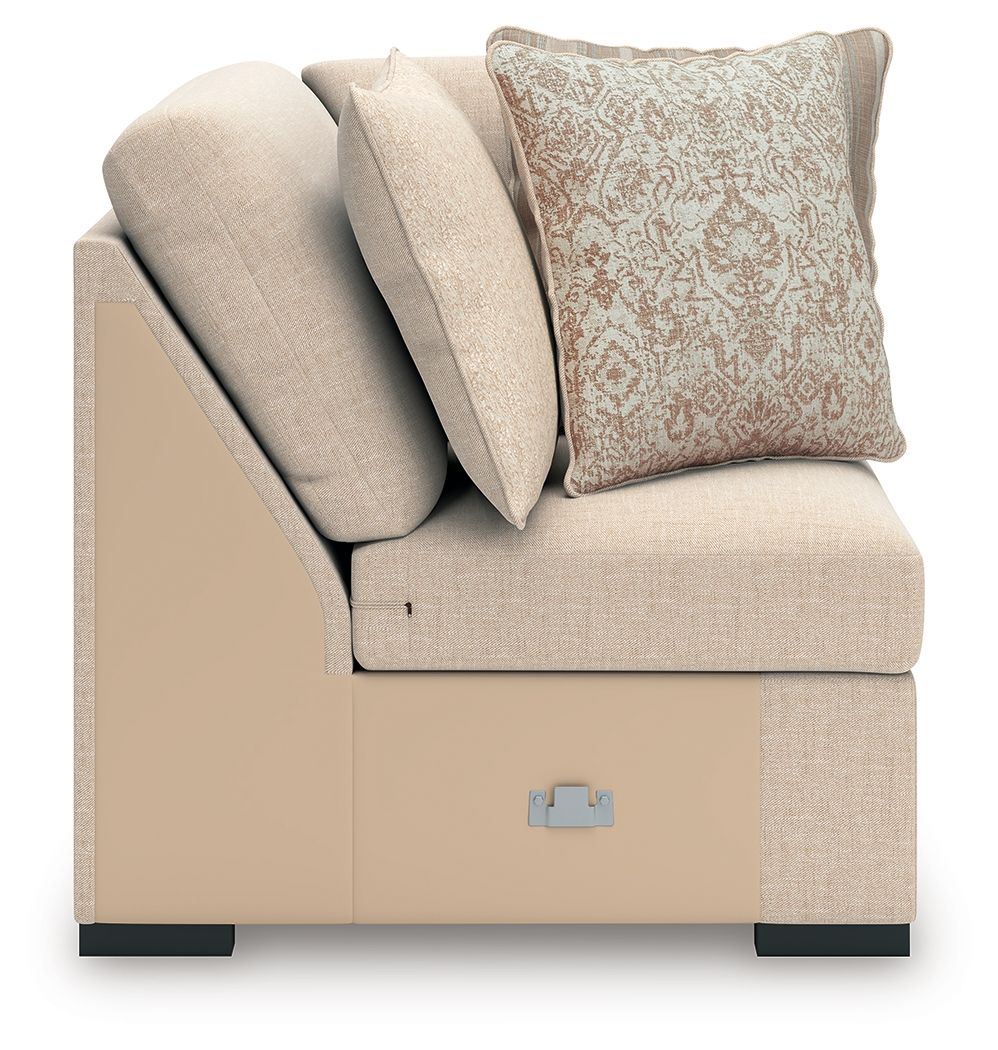 Light beige wedge chair with gray throw pillows and patterned accent pillow
