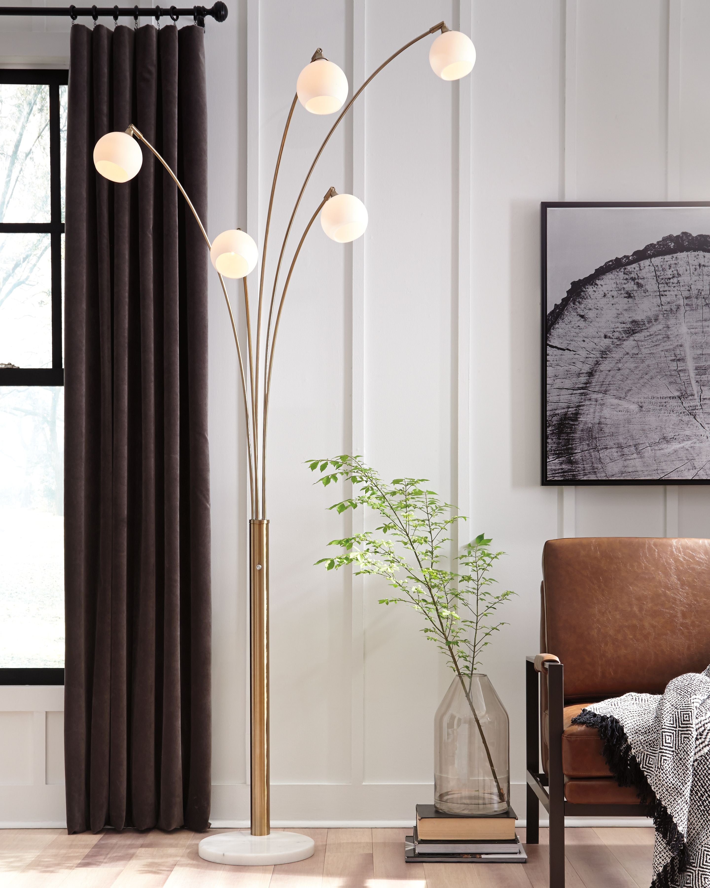 Metal arc floor lamp with champagne pole and five white globe shades