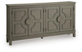 Warm gray accent cabinet with four paneled doors and round knob pulls
