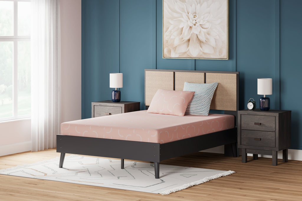 Kids mattress and pillow set with coral-pink sheet and pillow on bed frame