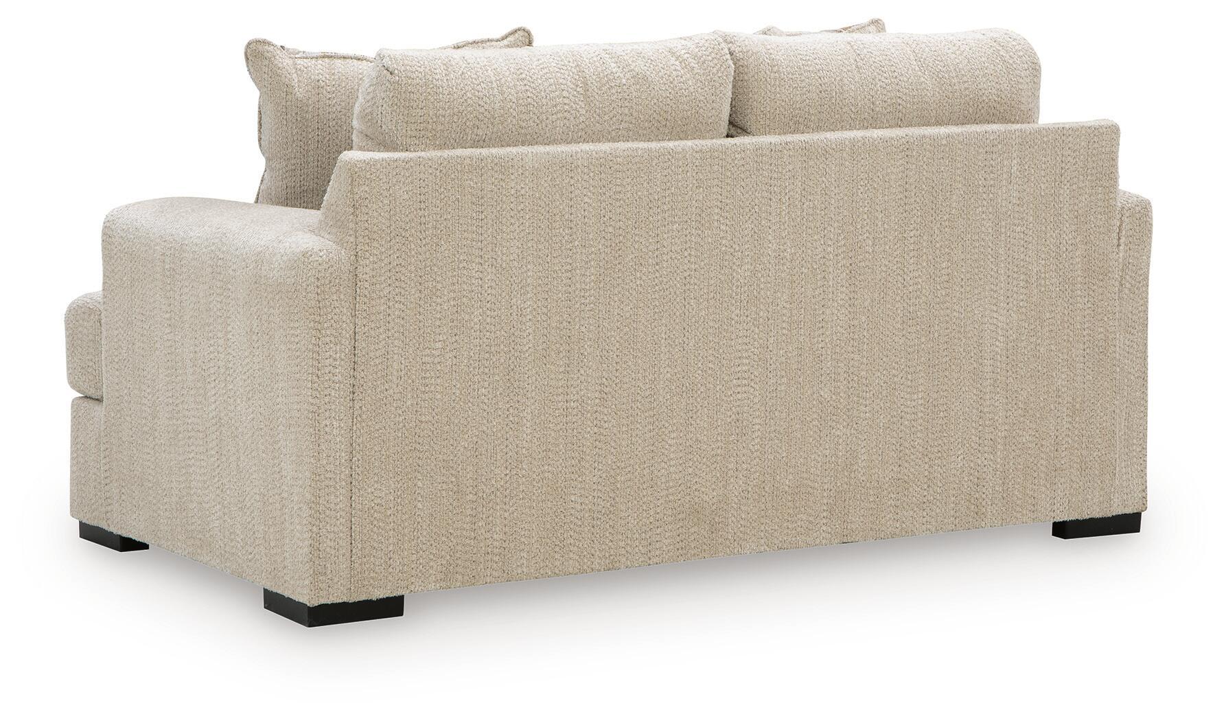 Beige loveseat with squared arms, two seat cushions, and matching solid throw pillows