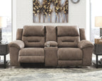 Reclining loveseat in taupe fabric upholstery, padded headrests and armrests