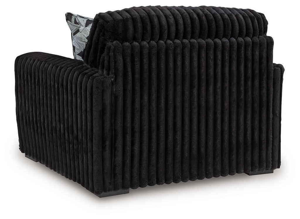 Black corduroy chair and a half with thick rounded arms and cushioned back