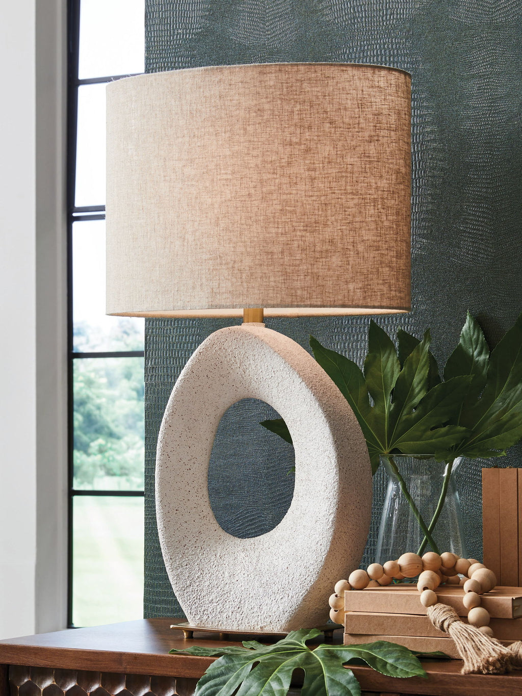 Paper table lamp with cream fabric shade and speckled oval stone base