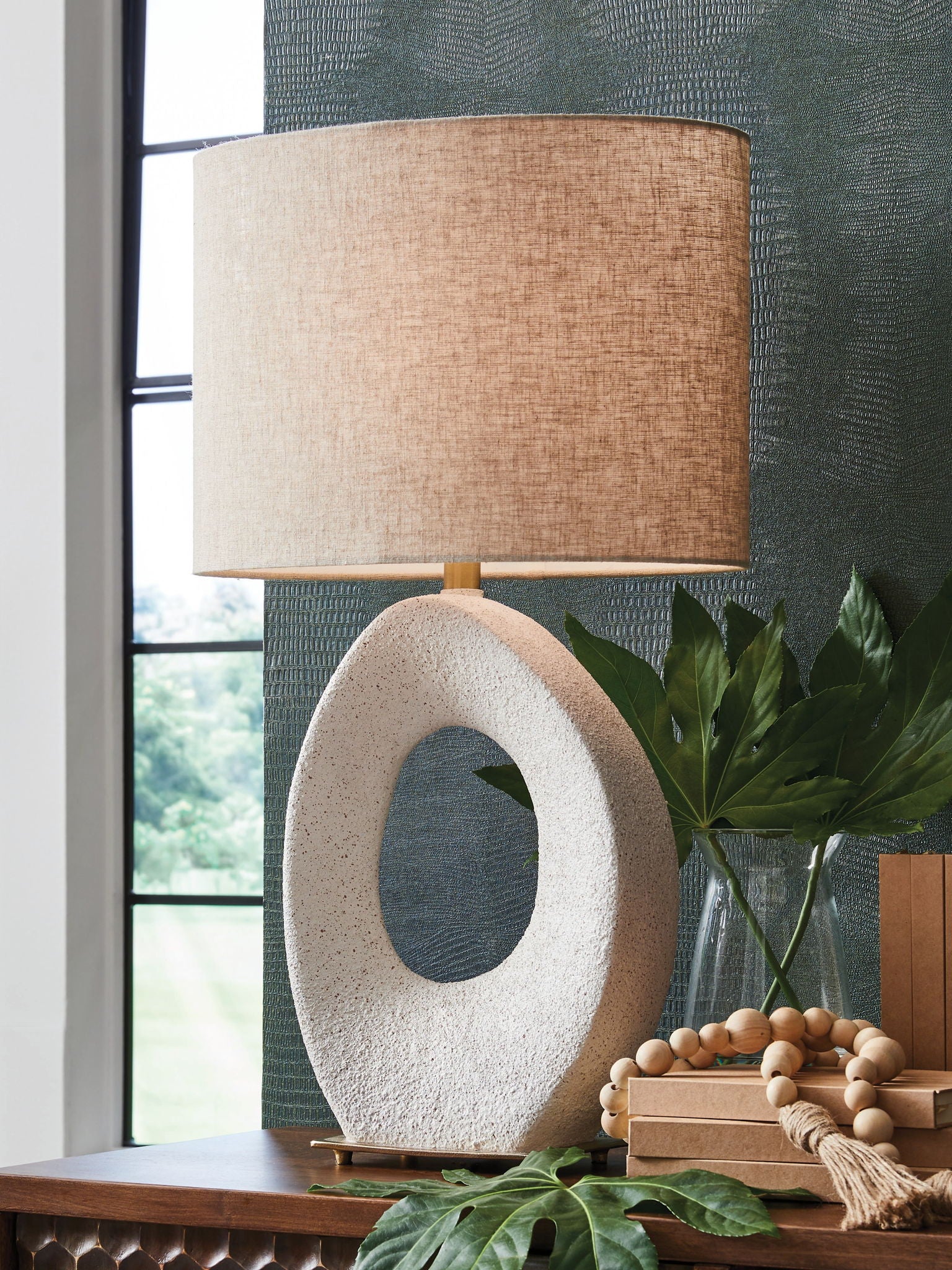 Paper table lamp with cream fabric shade and speckled oval stone base