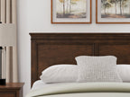 Brown queen panel headboard with top rail and inset rectangular panels