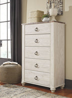 Five-drawer chest in distressed light wood with dark metal knob pulls and flared feet