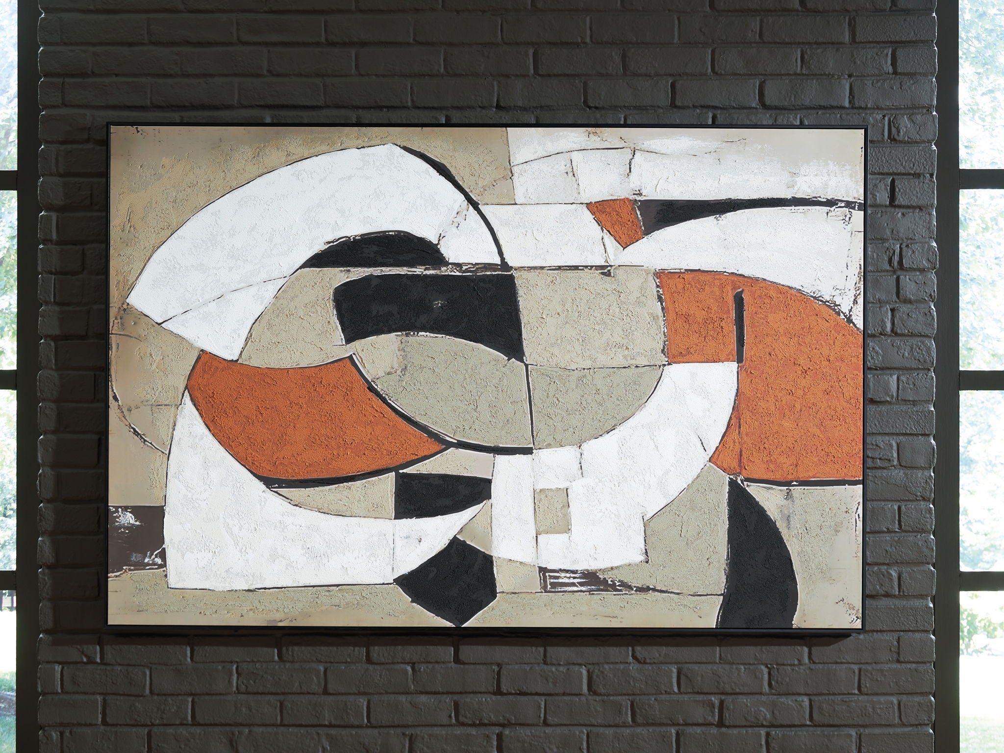 Framed abstract wall art featuring circular and ribbon-like forms in white, black, and rust