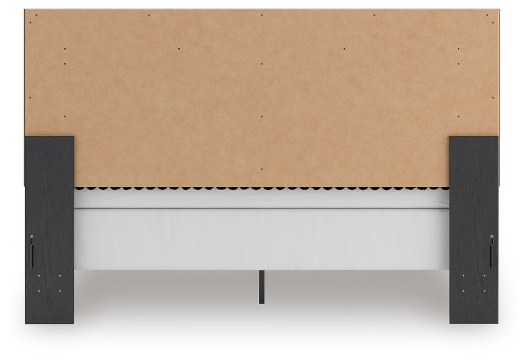 Upholstered panel bed base with tan fabric skirt and dark legs, shown from the front underside