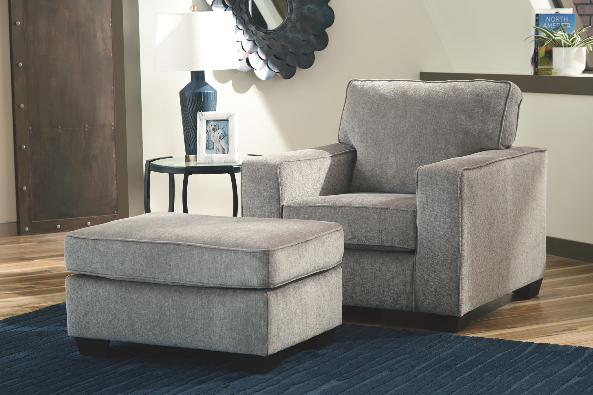 Gray fabric armchair and ottoman with square cushioned arms