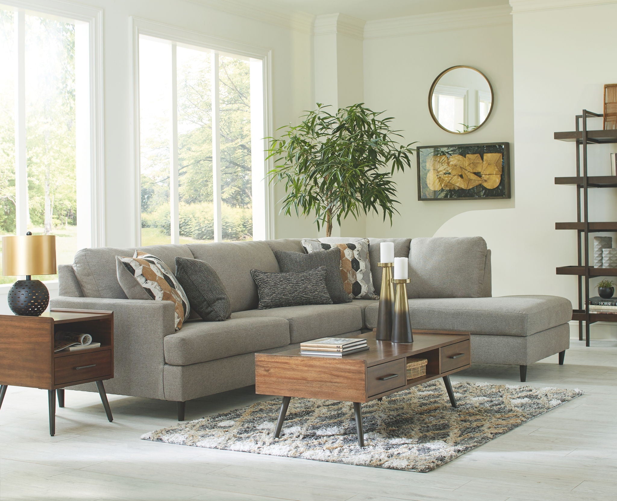 Granite gray sectional sofa with chaise, tufted look cushions, and decorative throw pillows