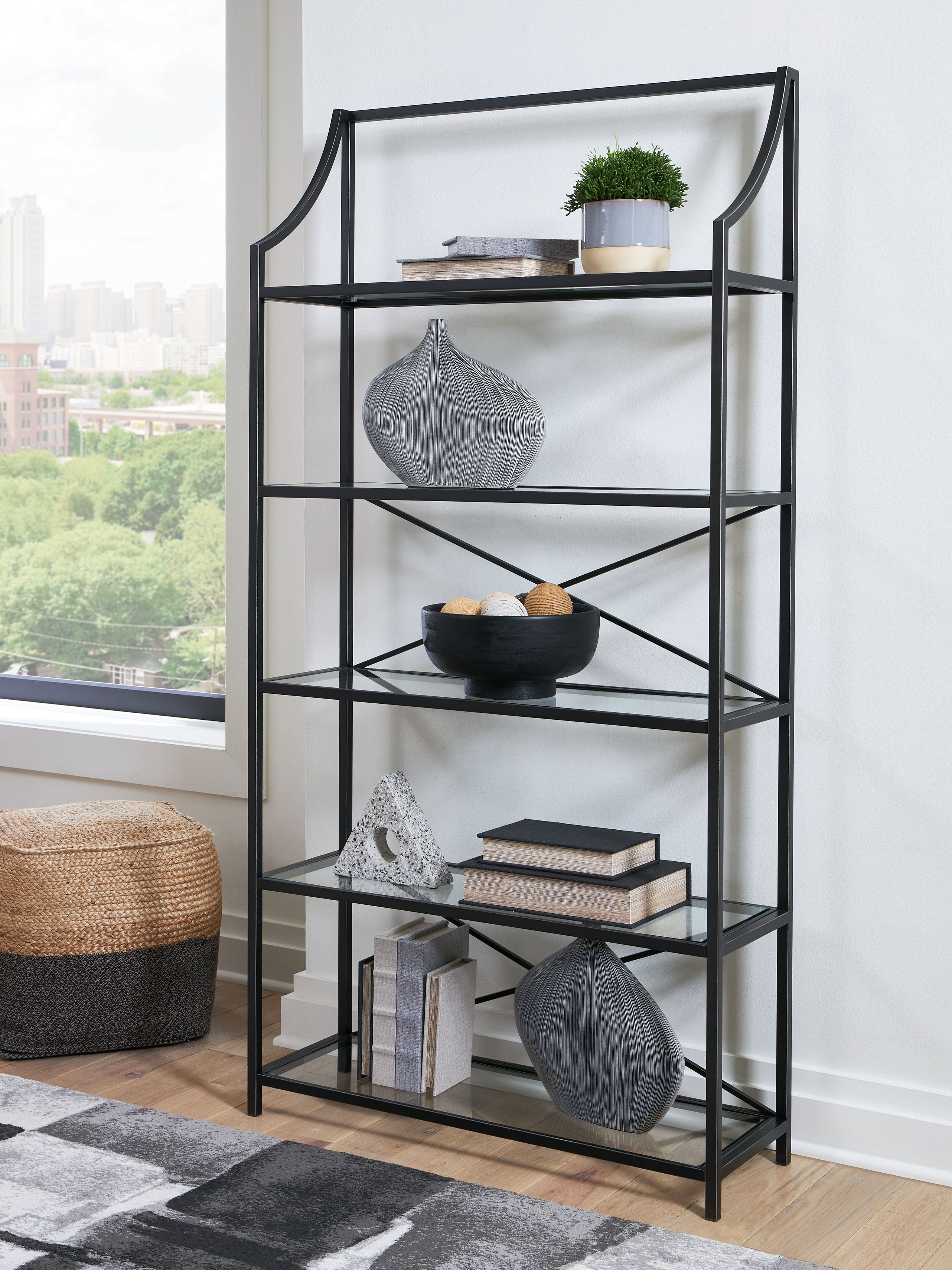 Antique black bookcase with five open shelves and curved uprights