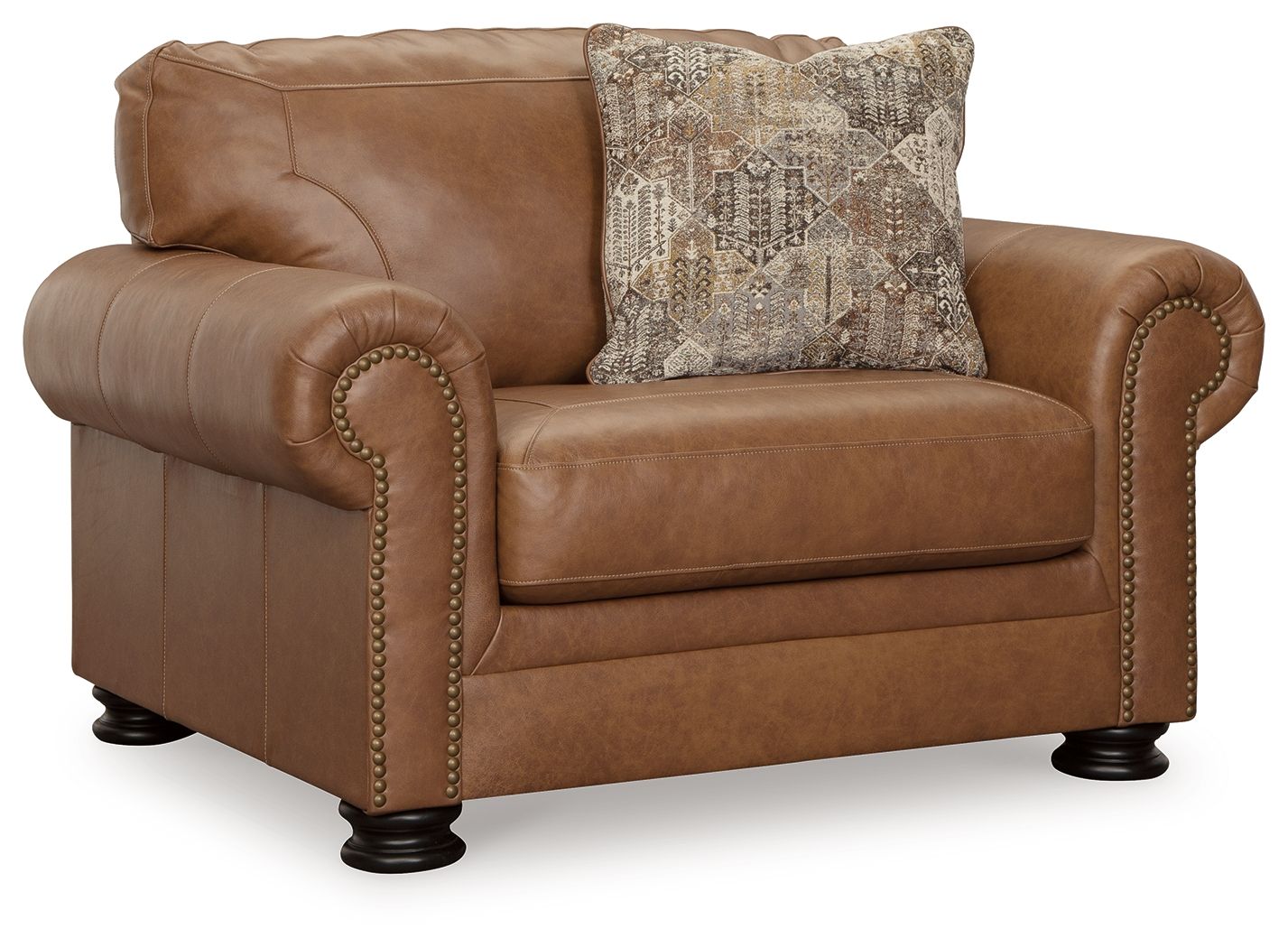 Brown upholstered armchair with rolled arms, nailhead trim, and patterned accent pillow