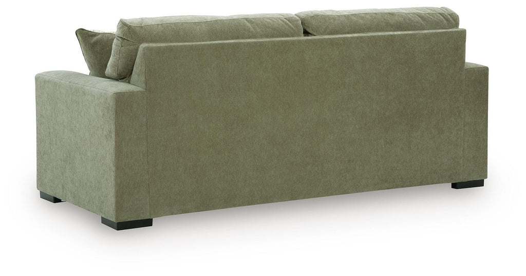 Green sofa sleeper with two matching headrest cushions and low black feet