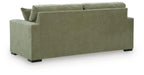 Green sofa sleeper with two matching headrest cushions and low black feet