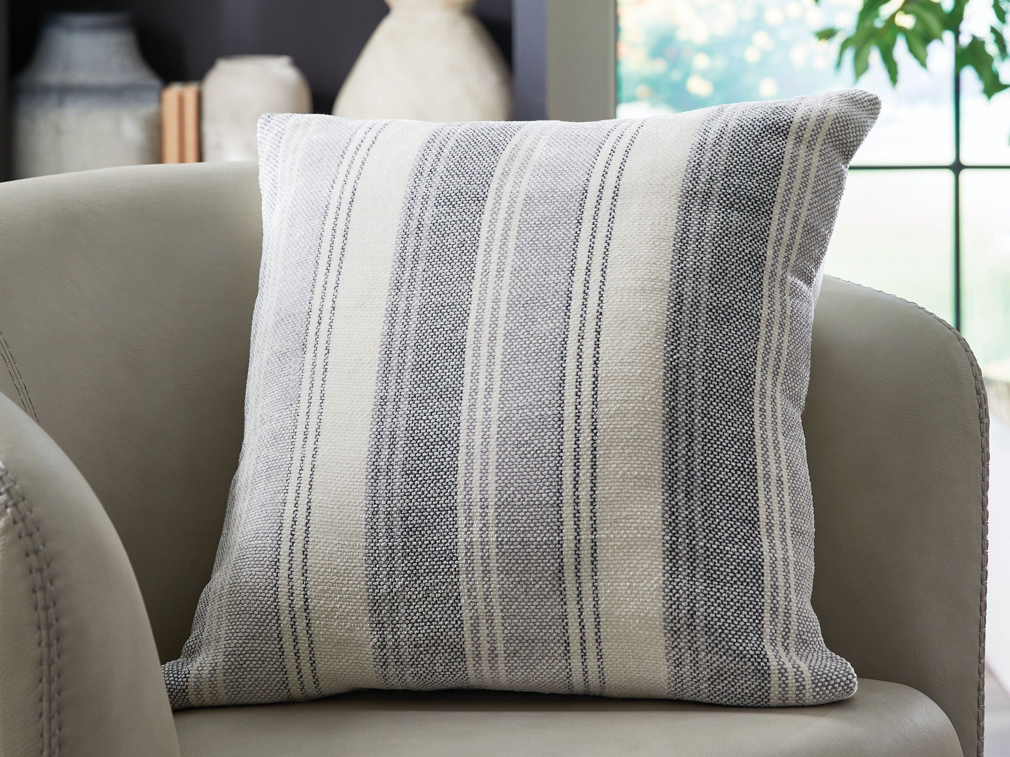Striped throw pillow in gray and white with blue vertical lines