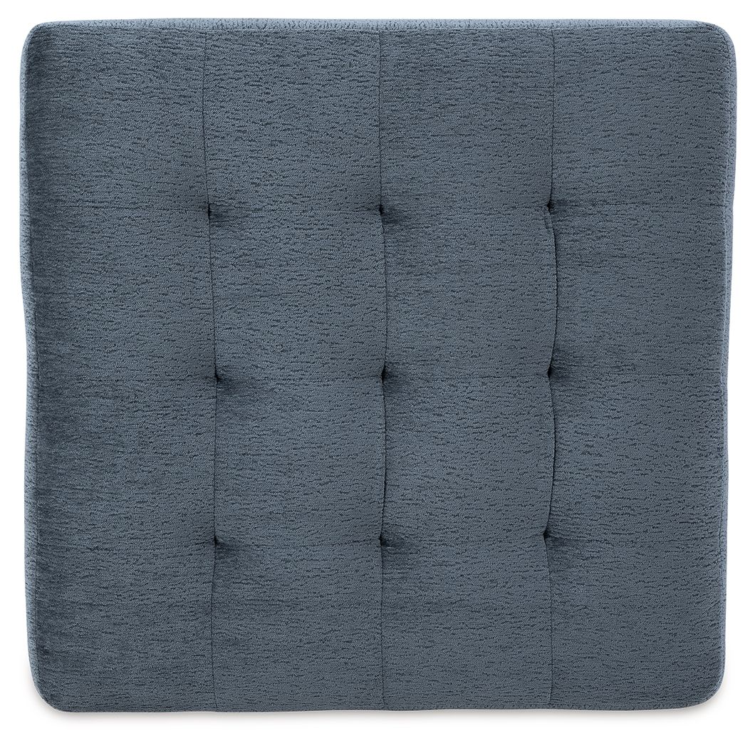 Blue upholstered ottoman top with stitched, square tufted pattern