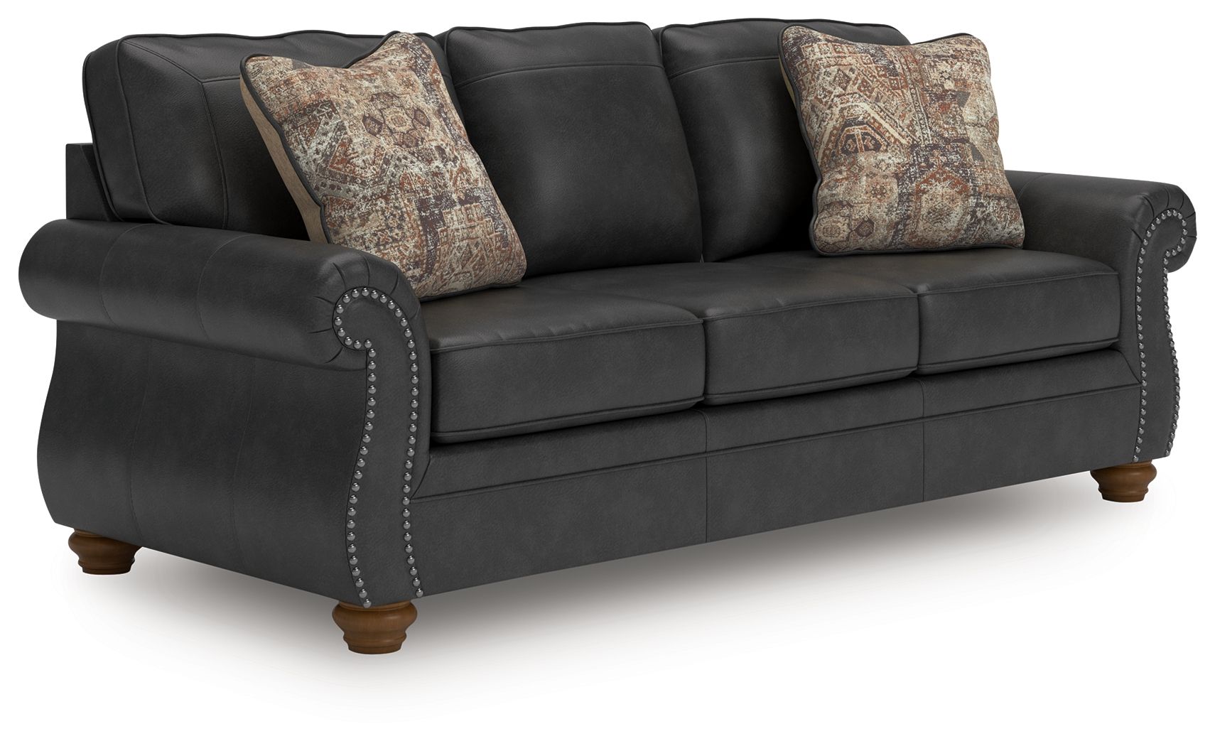 Chasemore sofa in dark gray with two patterned pillows and studded arm details