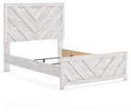 Light gray panel bed with chevron-pattern side rails and headboard, exposed slat base