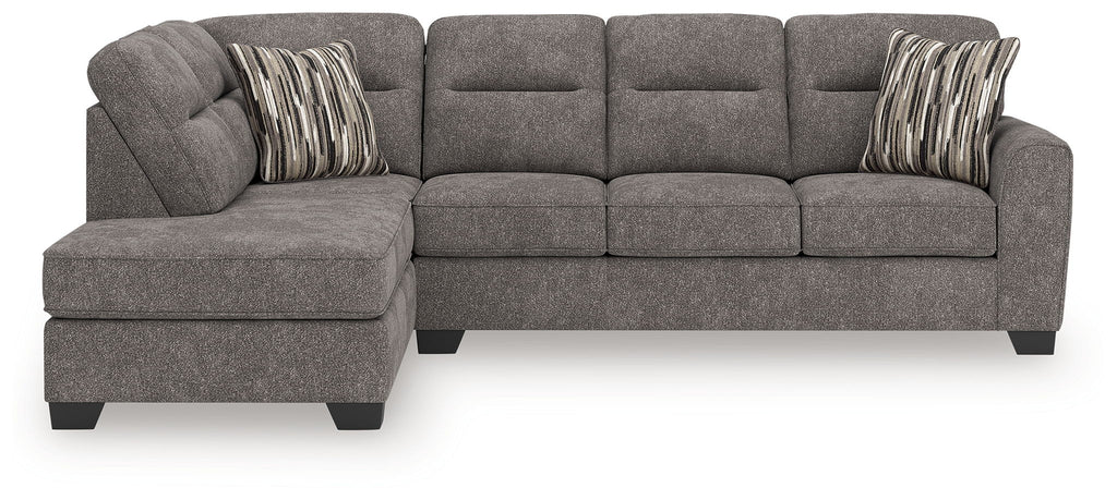 Dark gray 2-piece sectional sofa with left chaise, tufted back, and two striped throw pillows