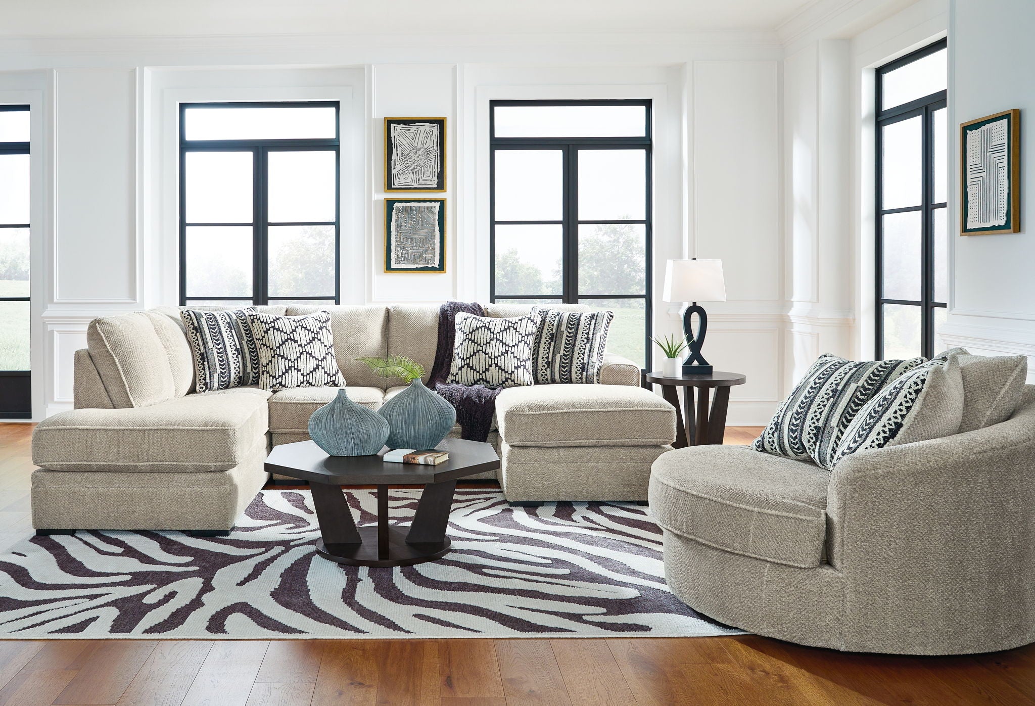 Beige corner chaise sectional sofa with patterned throw pillows and low, squared arms