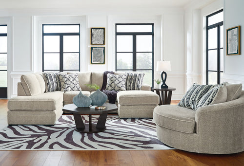 Beige corner chaise sectional sofa with patterned throw pillows and low, squared arms