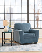 Blue upholstered armchair with rolled arms and thick seat cushion