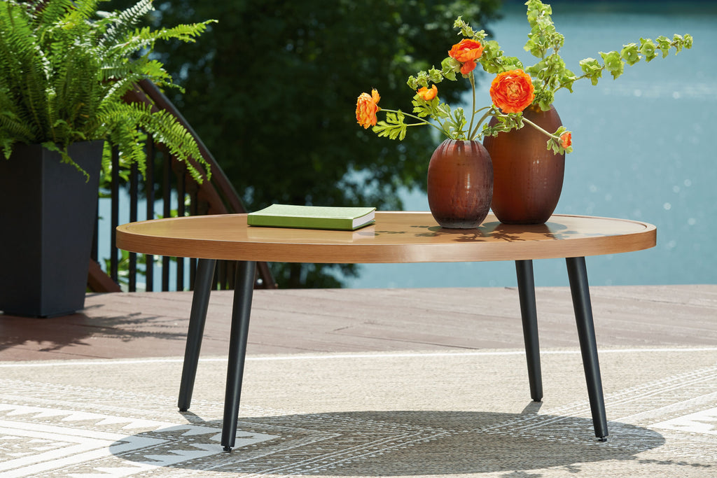 Round two-tone wood cocktail table with light brown top and dark legs