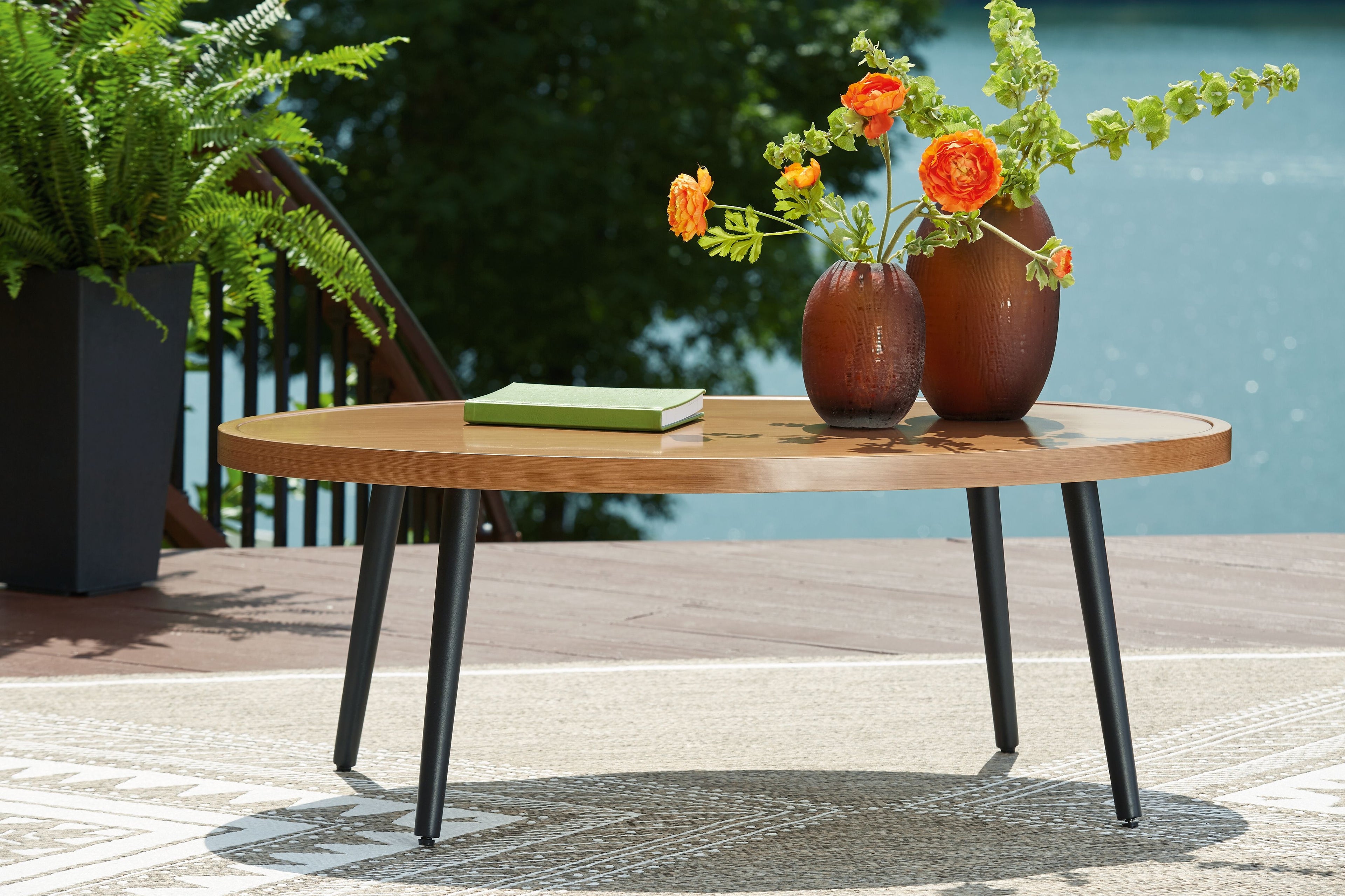 Round two-tone wood cocktail table with light brown top and dark legs