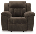Chocolate fabric rocker recliner chair with rounded arms and cushioned seat
