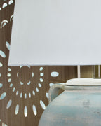 Table lamp with white drum shade and antique green ceramic vase neck
