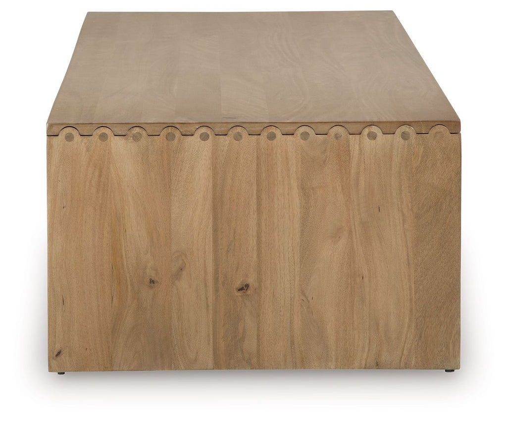 Light brown rectangular table with rounded-edge top and decorative side trim