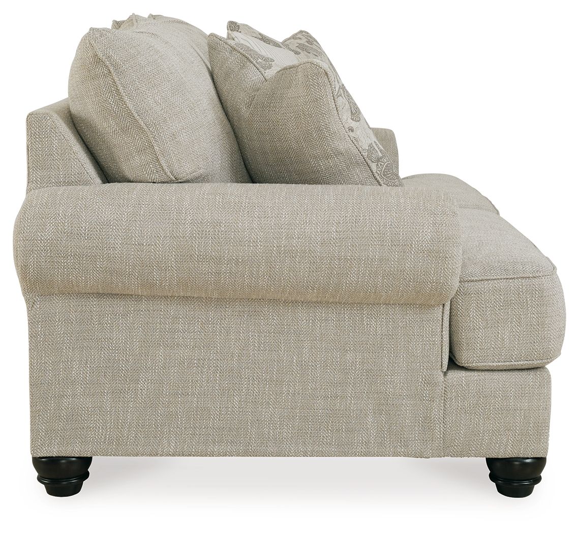 Light gray upholstered loveseat with textured fabric and rounded arm, side view.